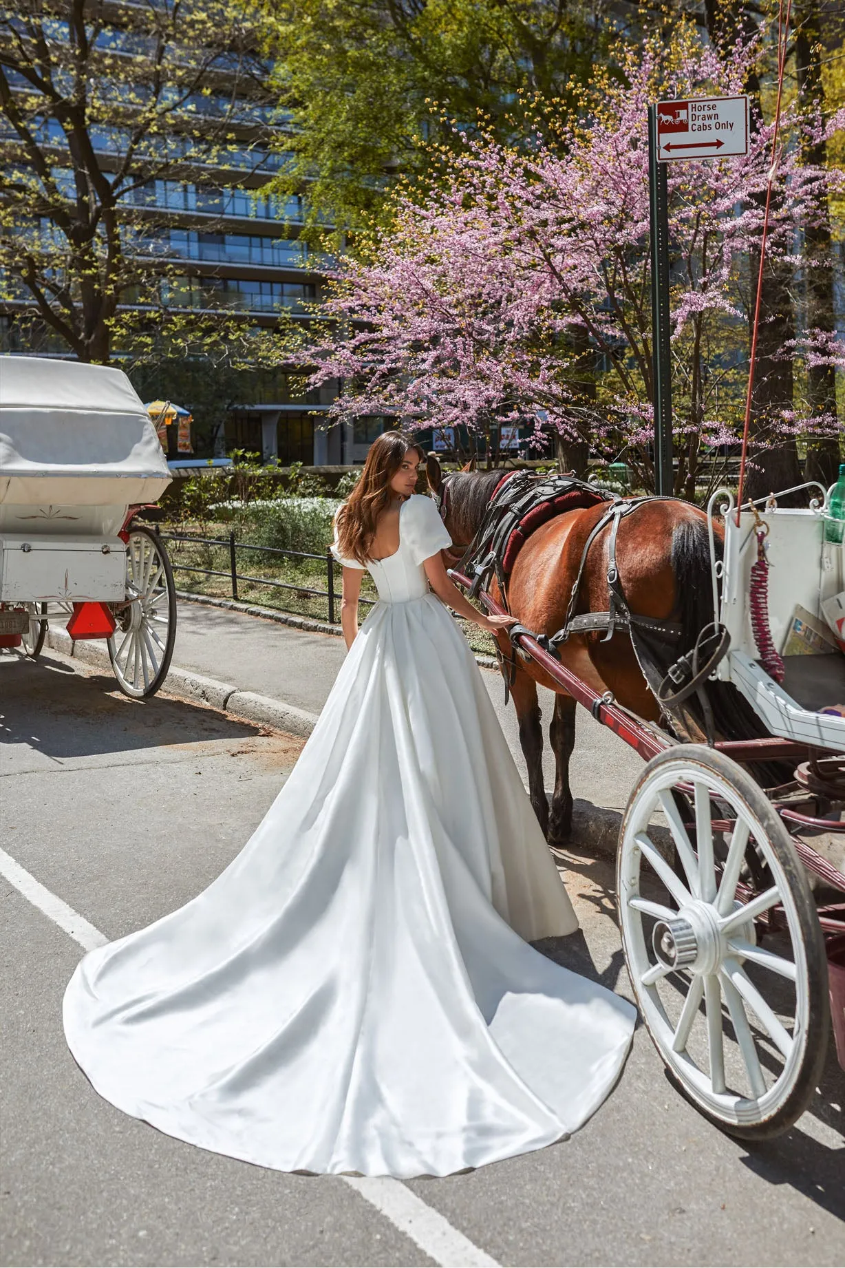 Gorgeous dress for a princess wedding look. The lush gown is made of glossy fabric and has no additional decorations. The corset is embellished with delicate Boat neckline and elbow-length loose sleeves with take-ups in the shoulders zone. - Image 4