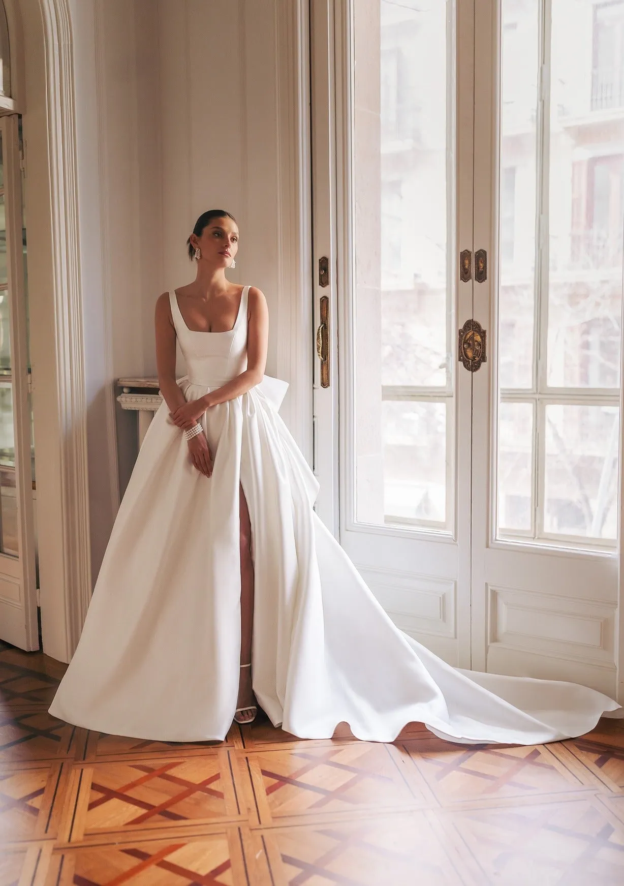 strapped dress with smooth rectangular neckline and simple lines. The bottom is a split gown-like skirt featuring a detachable wide ribbon bow. - Image 3