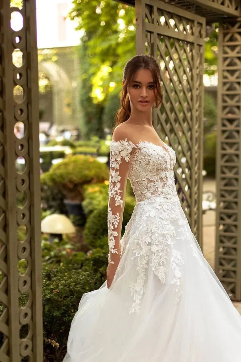Elegant A-Line Wedding Gown with Off-Shoulder Neckline, Long Sleeves, and a Graceful Dropped Waist for a Breathtaking Bridal Look - Image 3