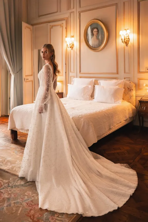 Elegant A-Line Wedding Gown with Puff Sleeves, Deep Neckline, Sequin Embellishments, and a Natural Waistline for a Timeless Bridal Look - Image 2