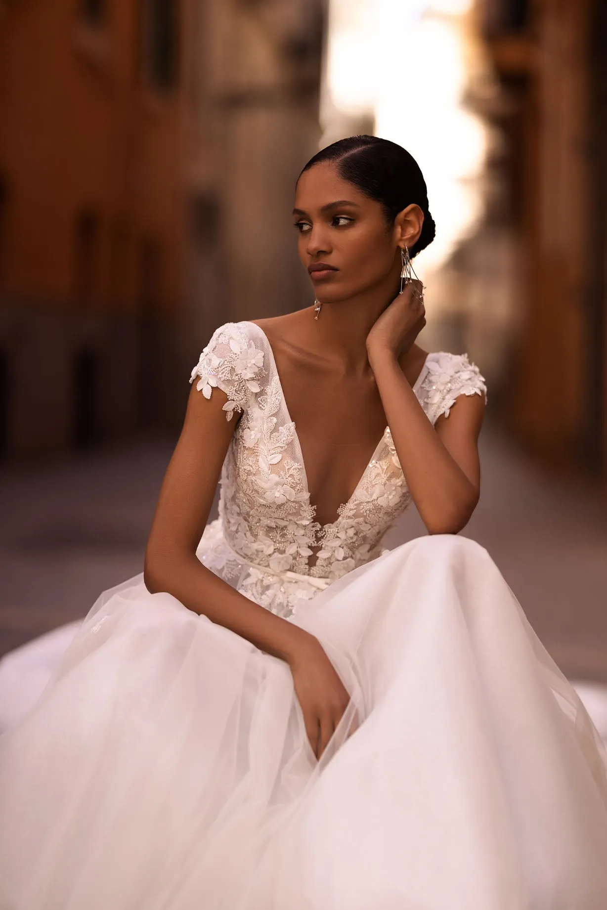 ntroducing our captivating A-line wedding dress, a vision of ethereal beauty and romance. Crafted from delicate tulle fabric, this dress exudes grace and femininity with every step. - Image 3