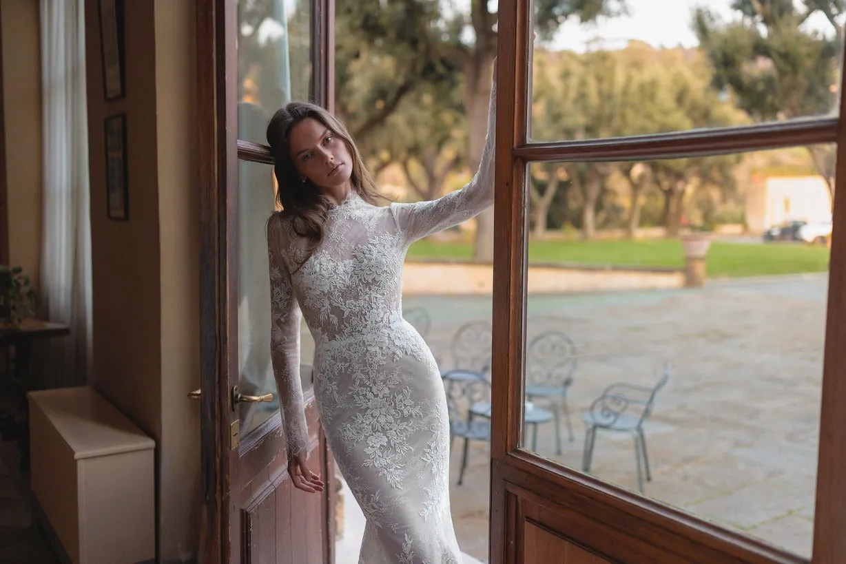Meticulously detailed embroidery over the translucent long sleeve top and smooth mermaid tail skirt. - Image 2