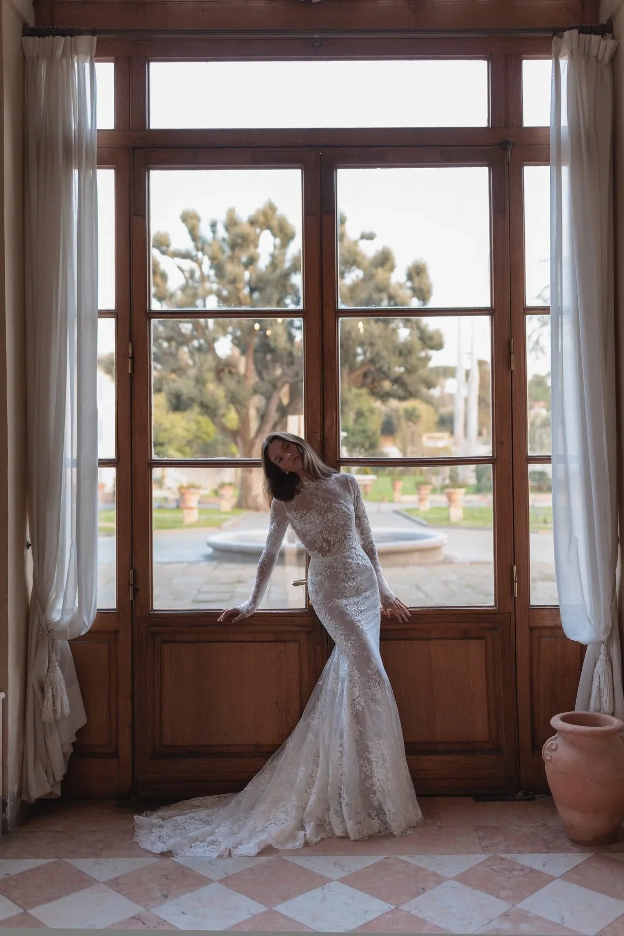 Meticulously detailed embroidery over the translucent long sleeve top and smooth mermaid tail skirt. - Image 3
