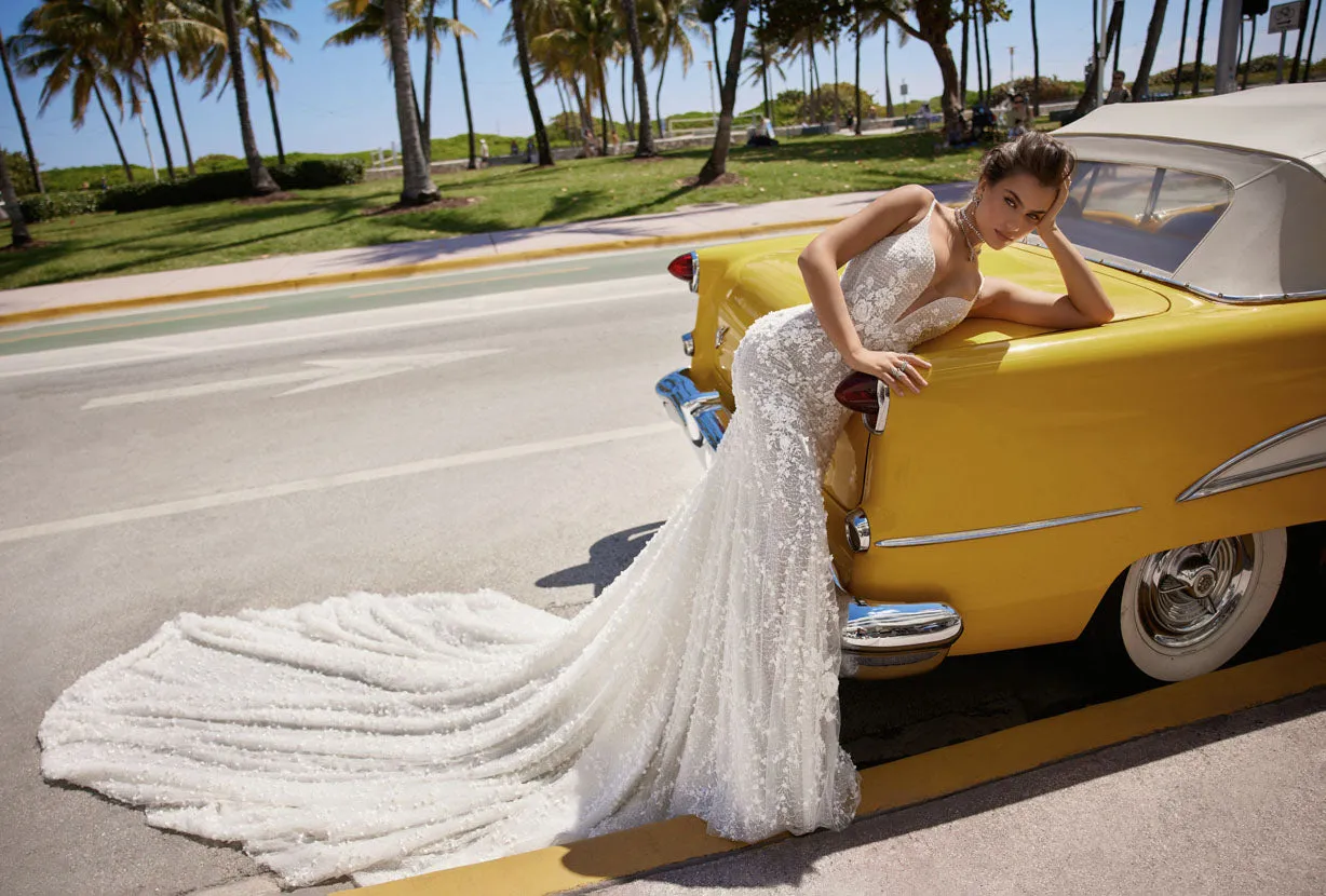 Bloom into a breathtaking bride in this floral lace mermaid wedding dress with a V-neckline and straps. The exquisite lace embellishments embrace your figure, flowing into a dramatic train, leaving a lasting impression on your big day. - Image 3