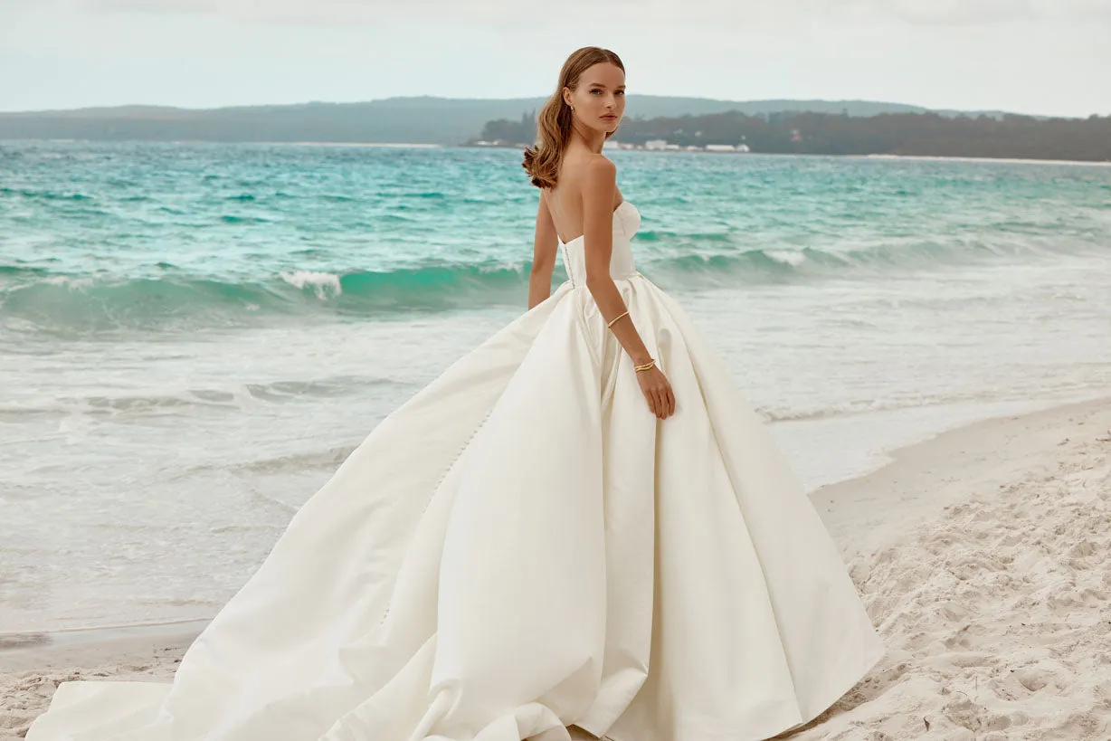 The strapless neckline exudes modern chic, making it a perfect choice for the bride who desires a look that seamlessly blends classic charm with contemporary style on her special day. - Image 2