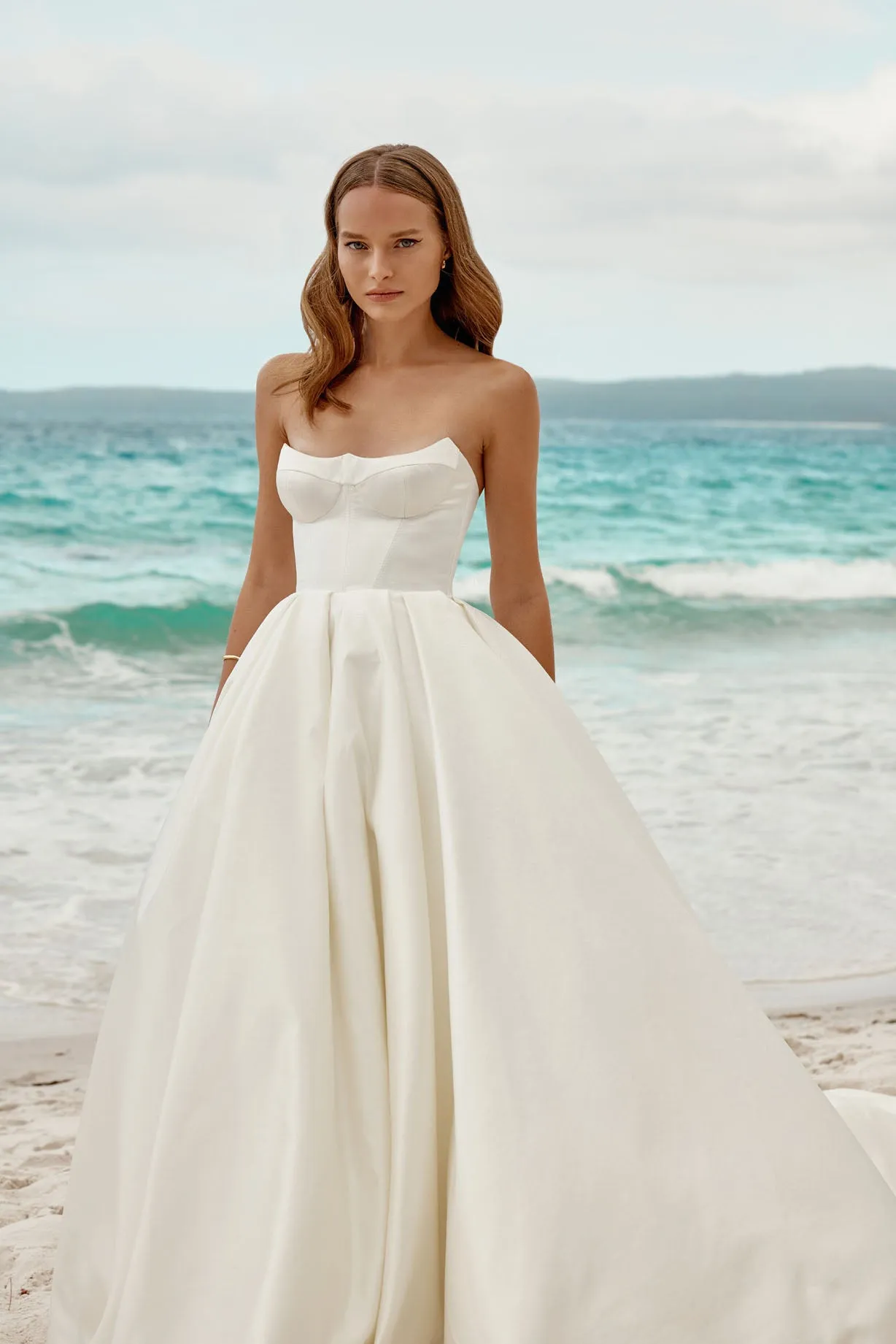 The strapless neckline exudes modern chic, making it a perfect choice for the bride who desires a look that seamlessly blends classic charm with contemporary style on her special day. - Image 3